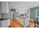Modern kitchen with a central island, white cabinetry, and elegant countertops at 740 Woodlawn Ave, Mount Holly, NC 28120