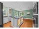 Charming eat-in kitchen featuring a stylish island with granite countertops, modern appliances, and hardwood floors at 740 Woodlawn Ave, Mount Holly, NC 28120