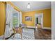 Bright yellow living room with natural light from a large window and decor creates a warm and inviting space at 740 Woodlawn Ave, Mount Holly, NC 28120