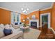 Bright and cozy living room featuring hardwood floors, fireplace, a large window, and comfortable seating at 740 Woodlawn Ave, Mount Holly, NC 28120