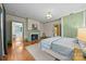 Spacious main bedroom with hardwood floors, fireplace, and attached bathroom for convenience at 740 Woodlawn Ave, Mount Holly, NC 28120