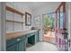 Mud room with custom cabinets and countertops featuring a view of a manicured outdoor garden at 740 Woodlawn Ave, Mount Holly, NC 28120