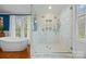 Elegant bathroom with a standalone tub next to marble tiled shower with glass surround and dual shower heads at 740 Woodlawn Ave, Mount Holly, NC 28120