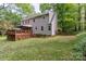 Large backyard showcasing a well-maintained lawn, deck, and appealing landscaping at 7514 Pewter Ln, Charlotte, NC 28270