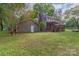 Spacious backyard showcasing a deck, patio area, and lush green lawn at 7514 Pewter Ln, Charlotte, NC 28270