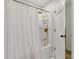 Bright bathroom featuring gold fixtures, a shower-tub combo, and a classic white tile backsplash at 7514 Pewter Ln, Charlotte, NC 28270