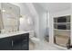 Modern bathroom features a dark vanity with gold fixtures and hexagon tile flooring at 7514 Pewter Ln, Charlotte, NC 28270