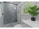 Bright bathroom showcases a tiled shower with glass door and marble countertop at 7514 Pewter Ln, Charlotte, NC 28270