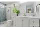 This bathroom features a white vanity with marble countertop and a tiled shower at 7514 Pewter Ln, Charlotte, NC 28270
