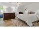This bedroom has a ceiling fan, neutral color palette, and light-colored flooring and rug at 7514 Pewter Ln, Charlotte, NC 28270