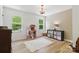 Bright bedroom with natural light from two windows, a dollhouse and a rug at 7514 Pewter Ln, Charlotte, NC 28270