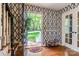 Inviting entryway featuring hardwood floors, stylish wallpaper, and a glimpse of the outdoors at 7514 Pewter Ln, Charlotte, NC 28270