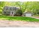 Charming two-story home featuring a well-kept lawn, a detached garage, and verdant surrounding foliage at 7514 Pewter Ln, Charlotte, NC 28270