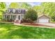 Charming home with a well-manicured lawn, complemented by a detached garage, enhancing its curb appeal at 7514 Pewter Ln, Charlotte, NC 28270