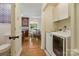 Hallway leading to a dining area and laundry area at 7514 Pewter Ln, Charlotte, NC 28270