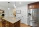Bright kitchen with stainless steel fridge, granite island, and lots of natural light at 7514 Pewter Ln, Charlotte, NC 28270