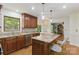 Kitchen featuring an island with granite countertops and pendant lighting at 7514 Pewter Ln, Charlotte, NC 28270