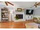 Cozy living room with hardwood floors, fireplace, and ceiling fans at 7514 Pewter Ln, Charlotte, NC 28270