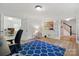 Spacious living room featuring hardwood floors, a blue patterned rug, and a cozy seating arrangement at 7514 Pewter Ln, Charlotte, NC 28270