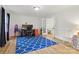 Bright living room with hardwood floors, a blue patterned rug, and ample natural light at 7514 Pewter Ln, Charlotte, NC 28270