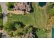 An aerial view showcases the expansive estate with a brick driveway, lush landscaping and surrounding pond at 8100 Skye Knoll Dr # 144, Waxhaw, NC 28173