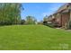 Sprawling backyard featuring mature trees and plush lawn on a sunny day at 8100 Skye Knoll Dr # 144, Waxhaw, NC 28173