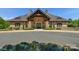 Exterior front view of the community clubhouse with a covered entry and colorful floral display at 8100 Skye Knoll Dr # 144, Waxhaw, NC 28173