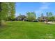 Expansive front yard with lush lawn and mature trees offering curb appeal and a sense of privacy at 8100 Skye Knoll Dr # 144, Waxhaw, NC 28173