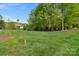 Expansive front yard featuring manicured lawn and mature trees on a sunny day at 8100 Skye Knoll Dr # 144, Waxhaw, NC 28173