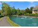 Scenic view of the pond with a water feature, lush landscaping, and a winding walking path at 8100 Skye Knoll Dr # 144, Waxhaw, NC 28173