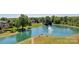 Picturesque pond with a fountain surrounded by mature trees and a tranquil seating area at 8100 Skye Knoll Dr # 144, Waxhaw, NC 28173