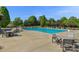 Community swimming pool surrounded by tables and lounge chairs at 8100 Skye Knoll Dr # 144, Waxhaw, NC 28173