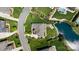 An aerial view of a house with a patio next to a pond in a verdant neighborhood at 9611 Pensive Ln, Waxhaw, NC 28173