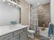 Stylish bathroom featuring a vanity with updated fixtures, shiplap walls, and a shower tub combination with curtain at 9611 Pensive Ln, Waxhaw, NC 28173