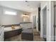 Bright bathroom featuring a corner soaking tub, white cabinets and a glass shower at 9611 Pensive Ln, Waxhaw, NC 28173