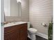 Chic powder room showcases a modern wood vanity, sleek fixtures, and planked walls at 9611 Pensive Ln, Waxhaw, NC 28173