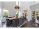 Dining area with high ceilings, modern light fixture, and seamless flow to kitchen at 9611 Pensive Ln, Waxhaw, NC 28173