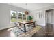 Bright dining room with a large table and scenic outdoor views from oversized windows at 9611 Pensive Ln, Waxhaw, NC 28173
