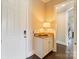 Welcoming foyer features white door, cabinet with countertop, and view into another room with beautiful hardwood floors at 9611 Pensive Ln, Waxhaw, NC 28173