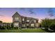 Beautiful two-story home featuring a manicured lawn, stone accents, and tasteful landscaping at 9611 Pensive Ln, Waxhaw, NC 28173