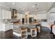 Gourmet kitchen featuring a large island with wood accents and modern pendant lighting at 9611 Pensive Ln, Waxhaw, NC 28173