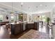 Open-concept kitchen with expansive island and stainless steel appliances at 9611 Pensive Ln, Waxhaw, NC 28173