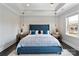 Serene main bedroom with a cozy blue bed, modern lighting, and a tray ceiling at 9611 Pensive Ln, Waxhaw, NC 28173