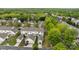 An aerial view of homes with individual garages nestled among lush, mature trees at 1001 Woodglen Ln, Matthews, NC 28104