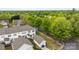 View of a suburban neighborhood showcasing houses with private garages amid mature trees at 1001 Woodglen Ln, Matthews, NC 28104