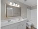 Bright bathroom featuring a dual sink vanity, large mirror, and combined shower and tub at 1001 Woodglen Ln, Matthews, NC 28104