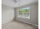 Cozy bedroom featuring a double window, neutral walls, carpet flooring, and a ceiling fan at 1001 Woodglen Ln, Matthews, NC 28104