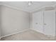Bedroom with carpet, double closet with white doors and ceiling fan at 1001 Woodglen Ln, Matthews, NC 28104