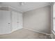 Bedroom featuring a double closet with white doors, neutral walls, carpet flooring, and a ceiling fan at 1001 Woodglen Ln, Matthews, NC 28104