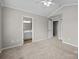 Spacious bedroom with neutral walls, carpet, ceiling fan, and access to ensuite bathroom at 1001 Woodglen Ln, Matthews, NC 28104